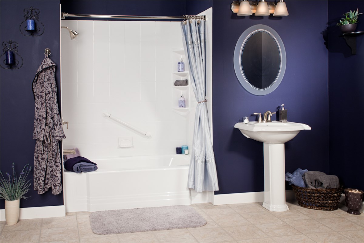 A bathroom featuring blue walls and white fixtures, creating a clean and modern aesthetic.