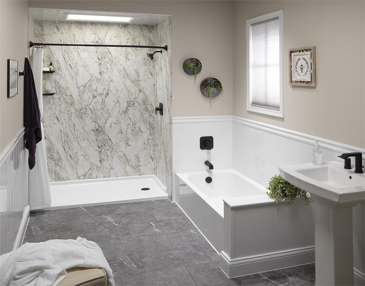A bathroom featuring a shower, bathtub, and toilet, with neutral-colored tiles and modern fixtures.