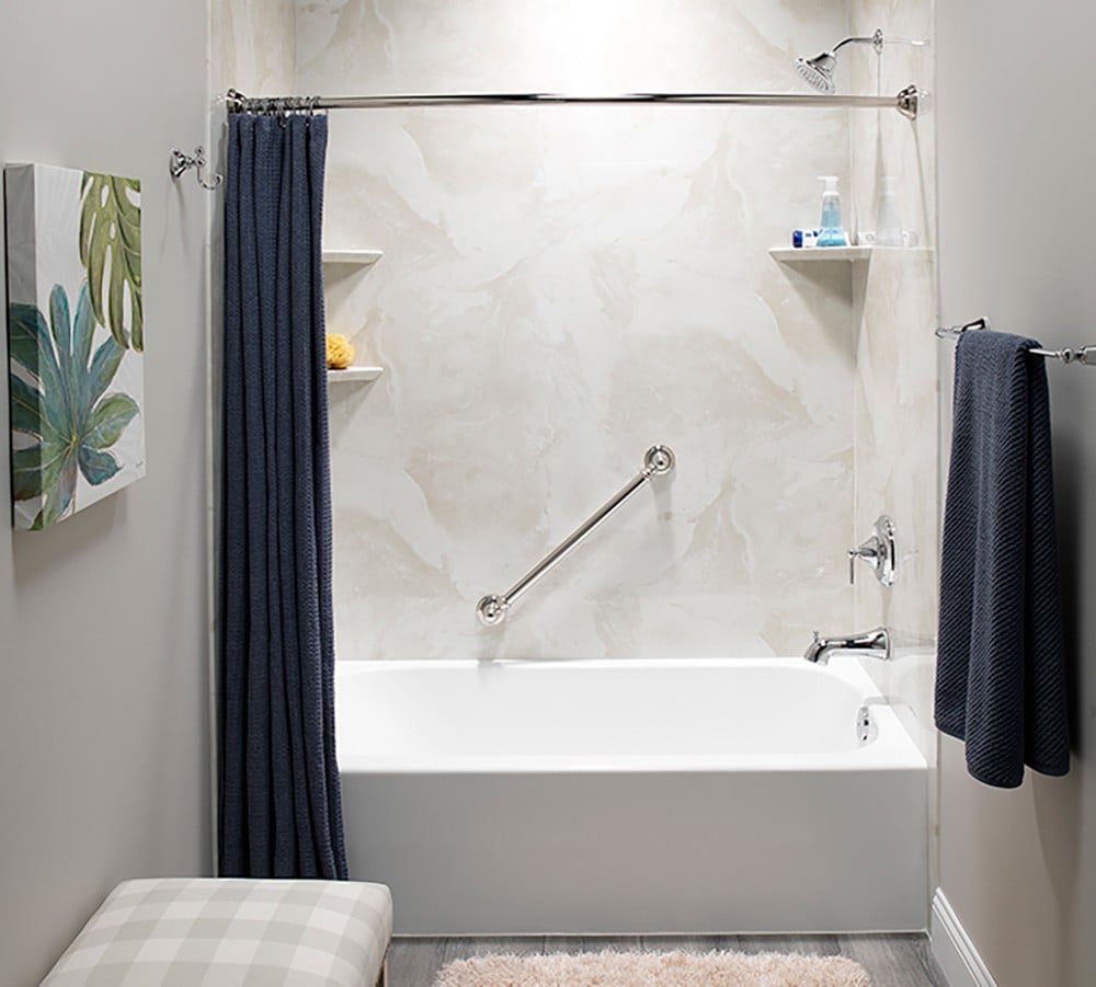 A bathroom featuring a bathtub, a shower, and a wooden bench against the wall.