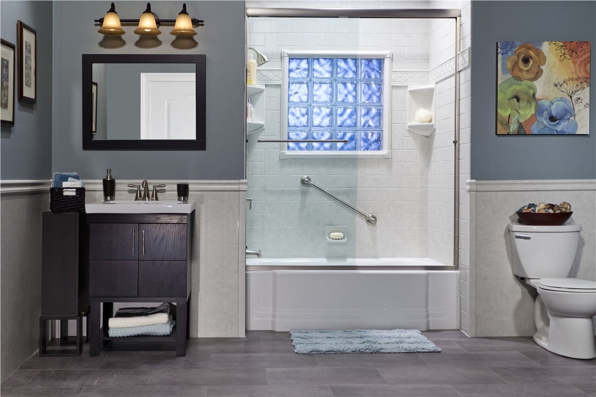 A bathroom featuring blue walls and gray tile flooring, creating a modern and calming atmosphere.