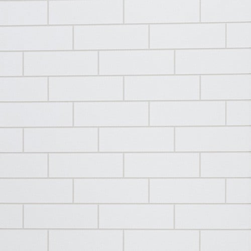 A white wall featuring a clean, uniform pattern of white subway tiles