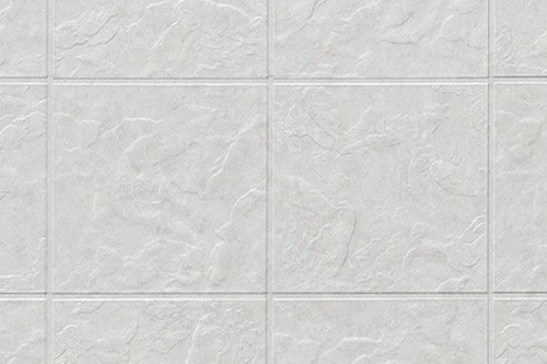 A white tile wall featuring a geometric pattern of squares in a clean, modern design