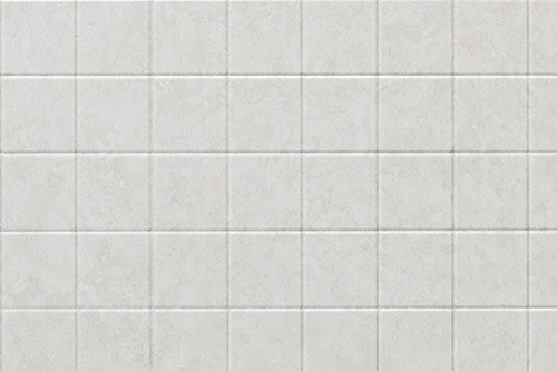 A white tiled wall featuring a modern shower head mounted at the top