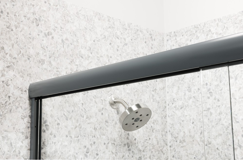 A modern shower featuring a clear glass door and an overhead shower head