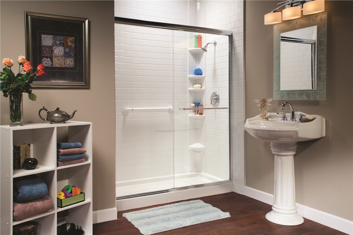 Bathroom featuring a shower, sink, and toilet, with neutral-colored tiles and modern fixtures