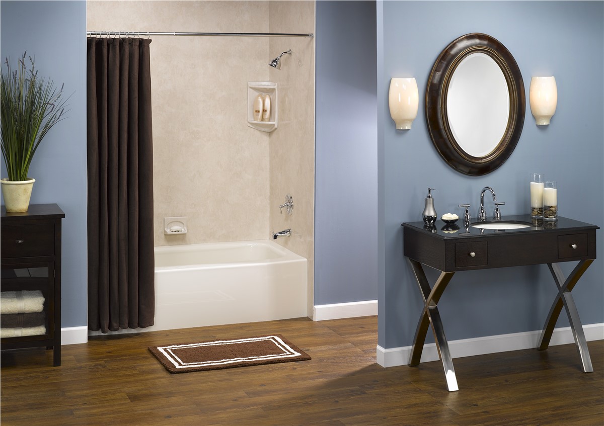A bathroom featuring a sink, toilet, and shower, with neutral-colored tiles and modern fixtures.